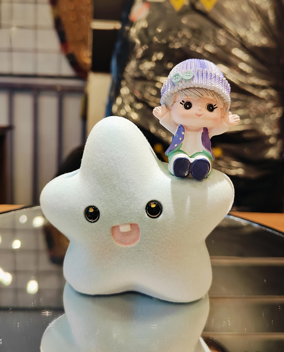 Girl sitting on star resin gift